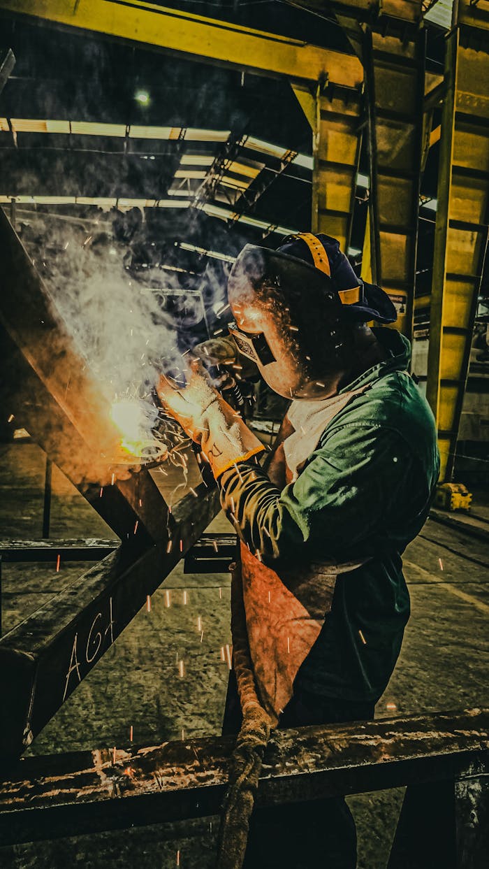 Mastering the First Impression: Your intriguing post title goes here A skilled welder works on metal fabrication in a Brazilian factory, showcasing industrial precision.
