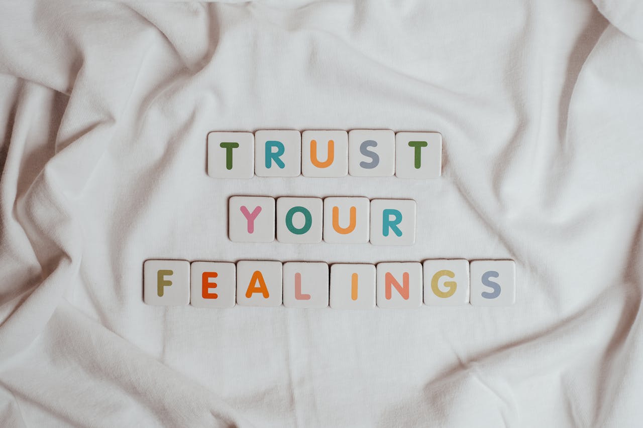 gallery-3 Colorful tiles spell out 'Trust your feelings' on a fabric background.