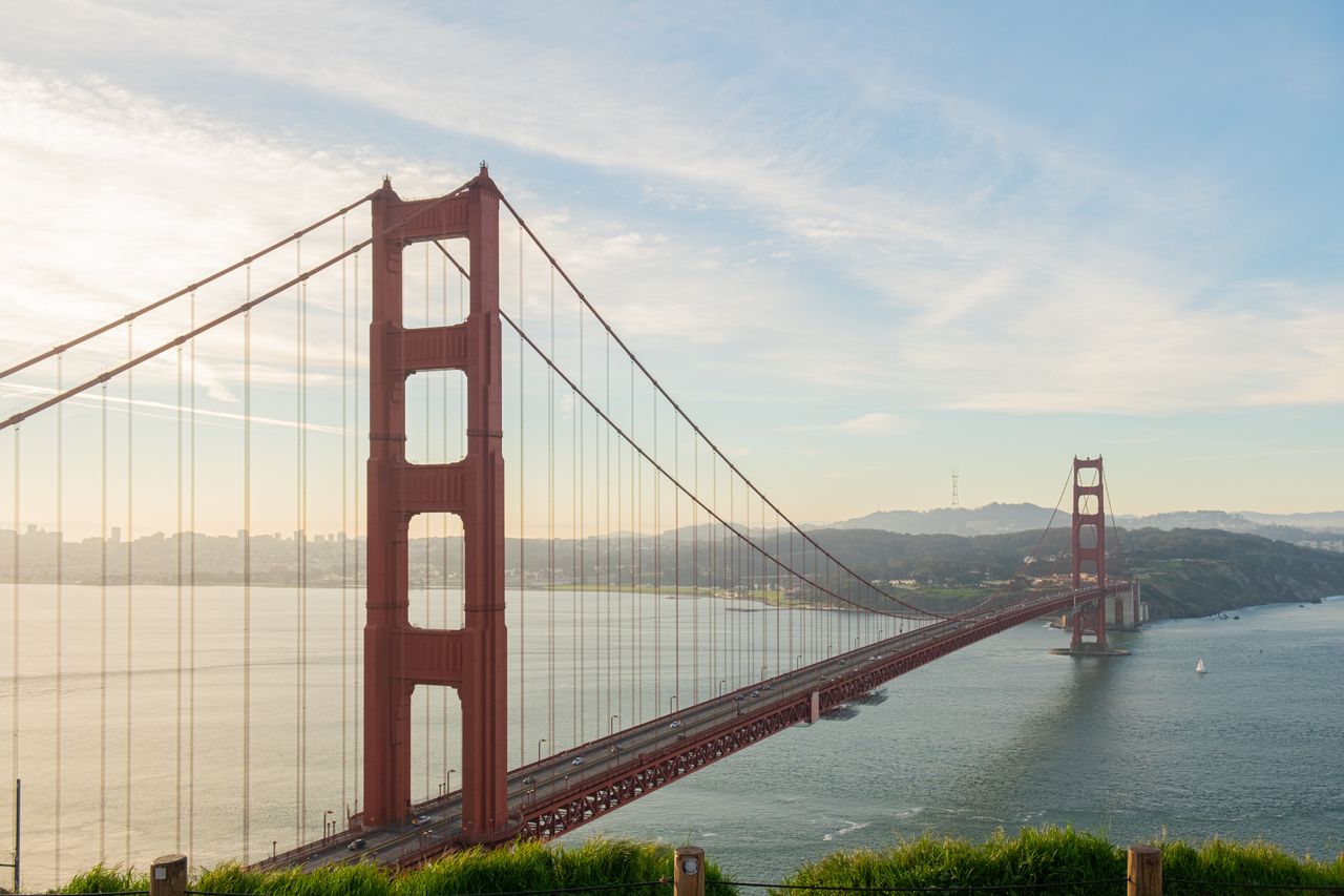 Iconic view of Golden Gate Bridge at sunset in San Francisco, California.
