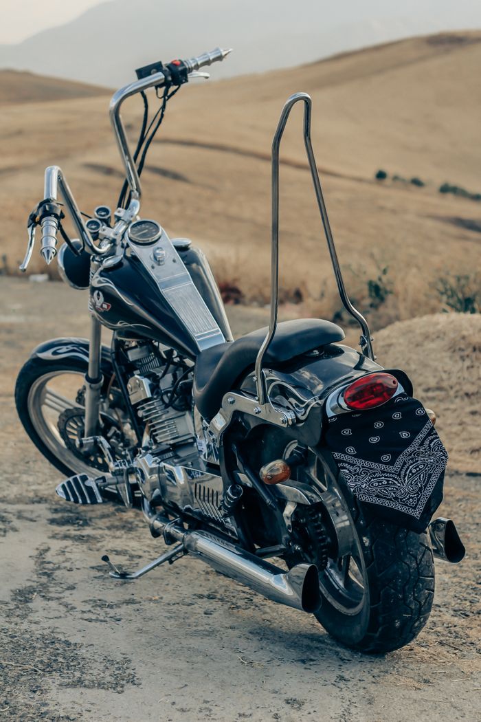 The Art of Drawing Readers In: Your attractive post title goes here A black motorcycle parked on a dirt road in Urmia, Iran, showcasing vintage design.